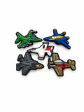 Five colourful aeroplane and jet shoe charms arranged on a white background